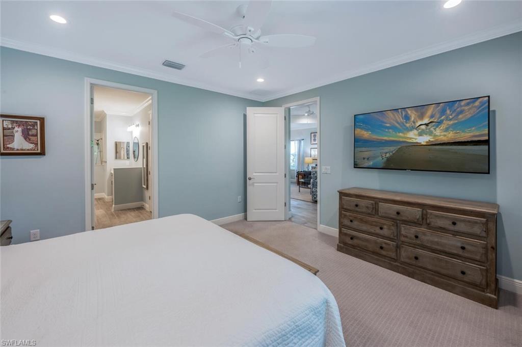 2211 Marquesa Circle Naples, FL 34112 - Photo 13 of 28 a bedroom with a bed and a flat screen tv