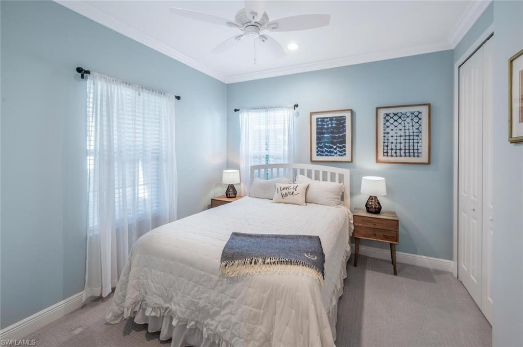 2211 Marquesa Circle Naples, FL 34112 - Photo 15 of 28 a bedroom with a bed and a table in it