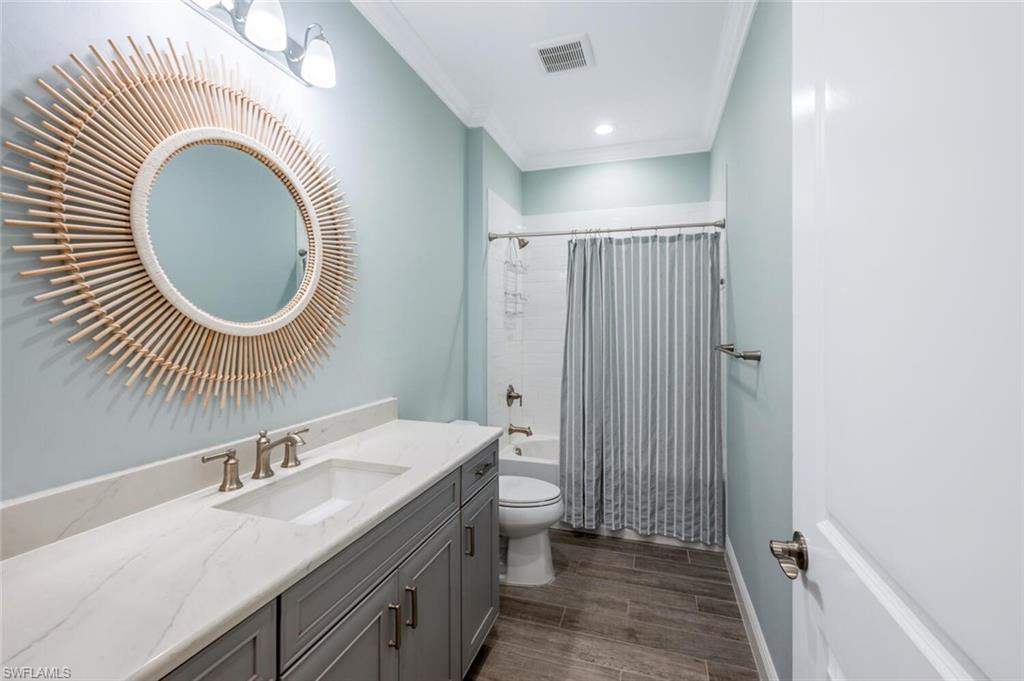 2211 Marquesa Circle Naples, FL 34112 - Photo 16 of 28 a bathroom with a toilet a sink and a mirror