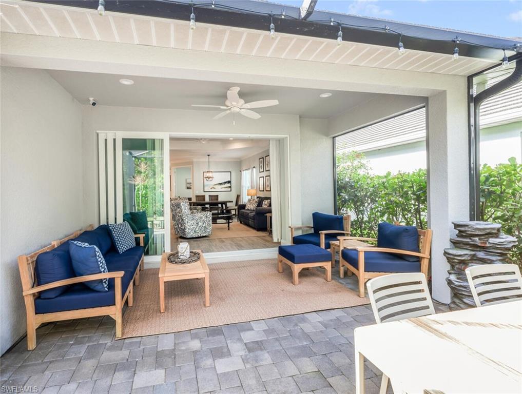 2211 Marquesa Circle Naples, FL 34112 - Photo 19 of 28 a living room with furniture and large windows