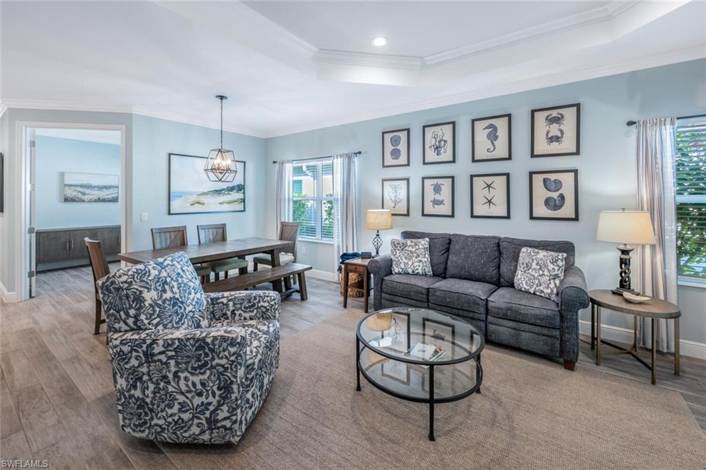 2211 Marquesa Circle Naples, FL 34112 - Photo 9 of 28 a living room with furniture and a painting on the wall