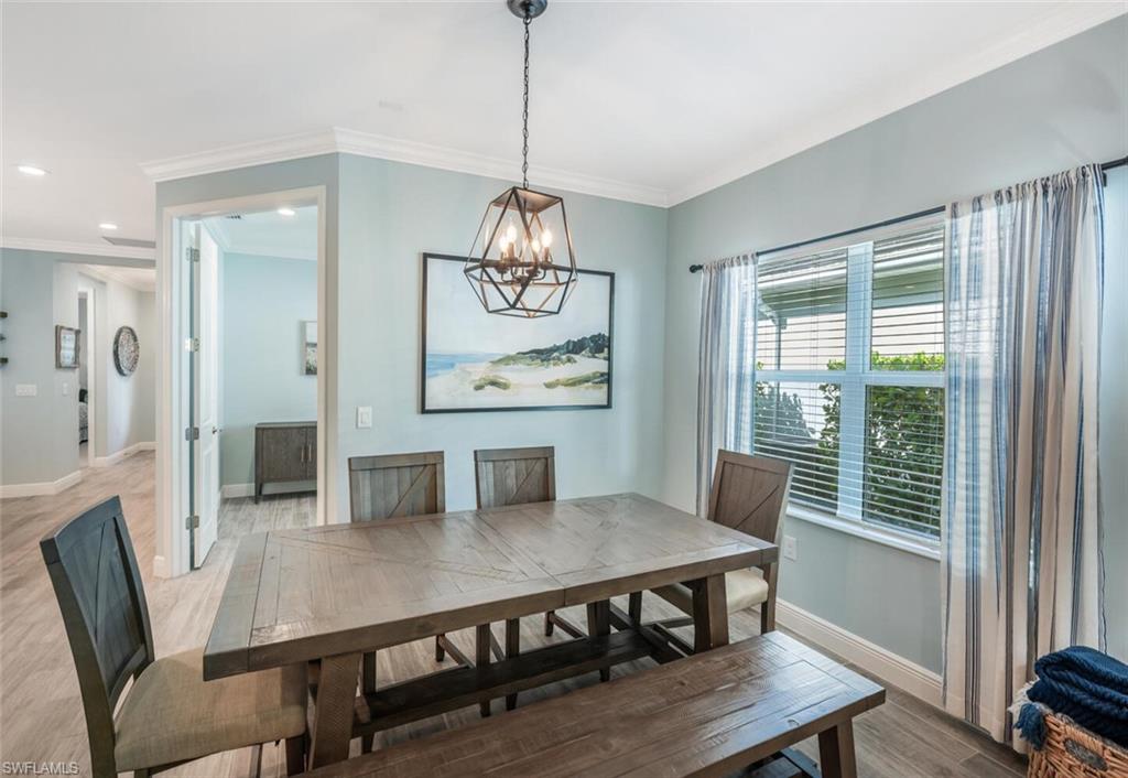 2211 Marquesa Circle Naples, FL 34112 - Photo 10 of 28 a view of a dining room with furniture window and wooden floor