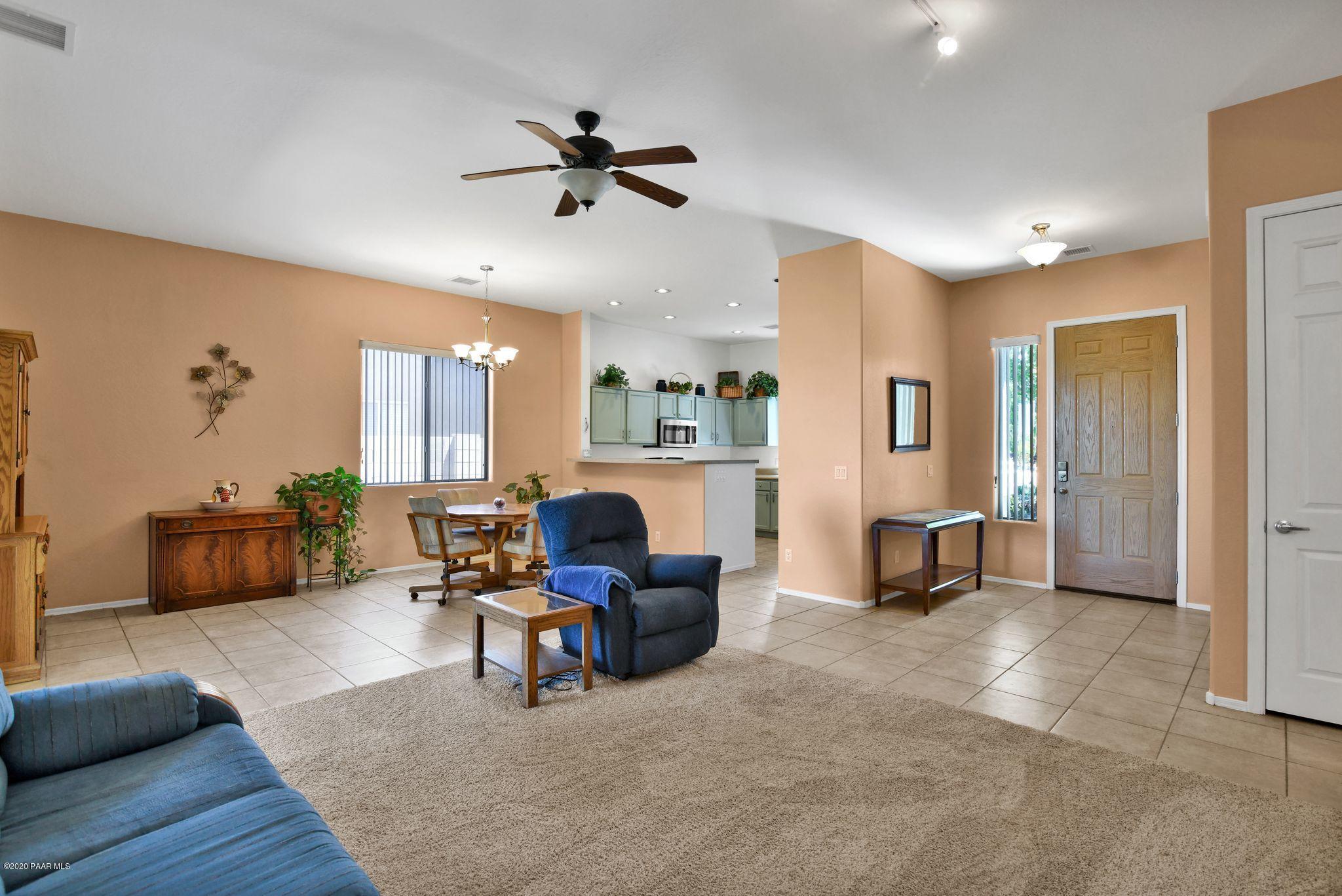 4762 Edgemont Road Prescott Valley, AZ 86314 - Photo 5 of 36 a living room with furniture and a view of kitchen