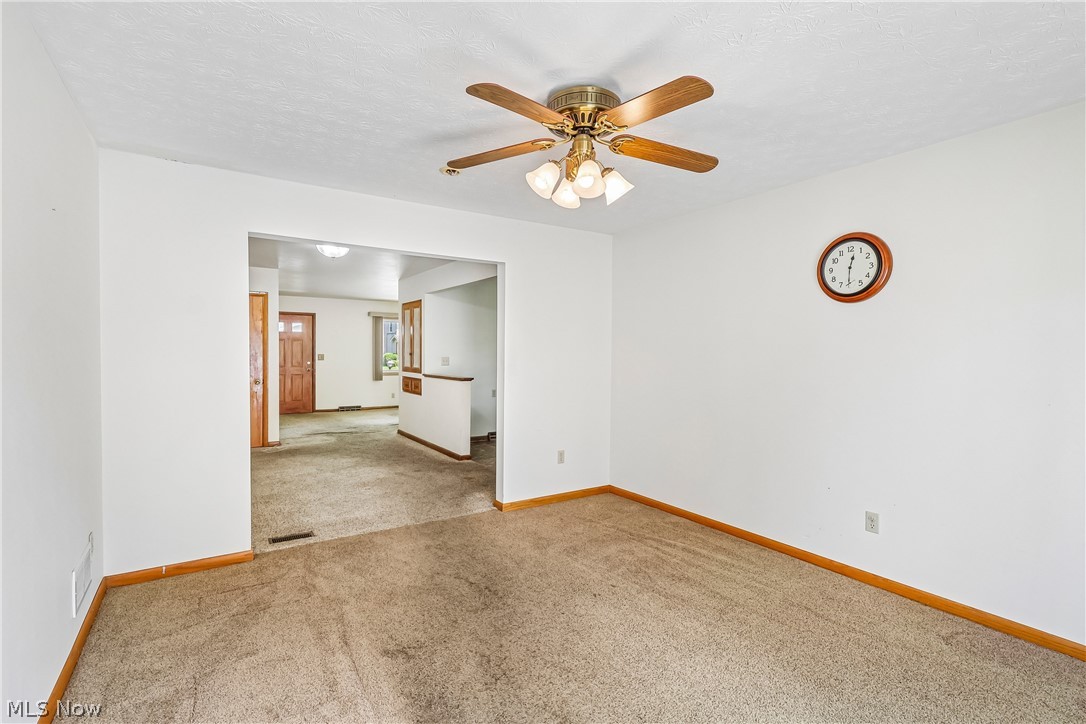 2758 Shellhart Road Norton, OH 44203 - Photo 12 of 41 Family room with ceiling / fan light, slider to deck and carpet flooring