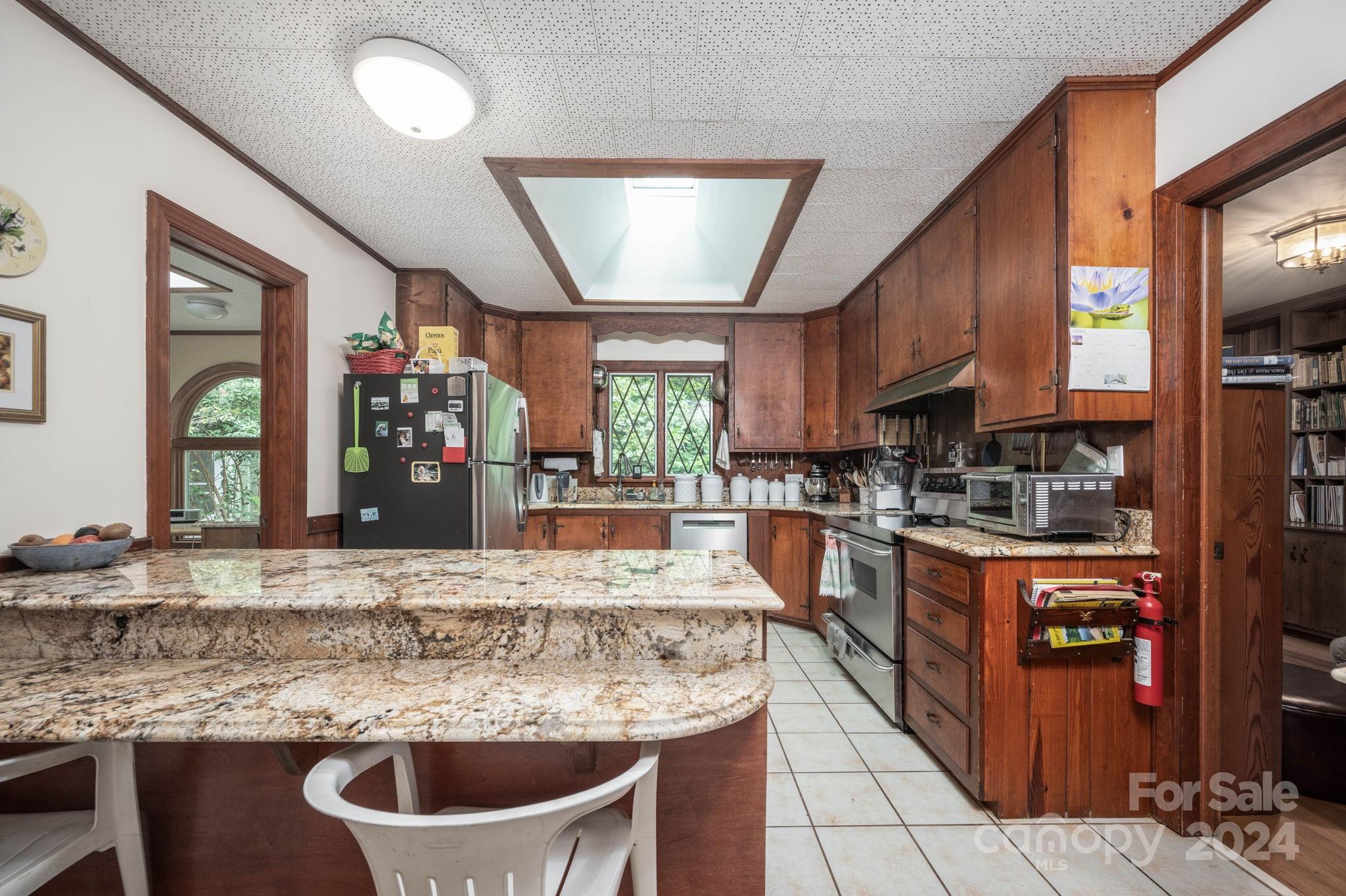 559 Lorimer Road Davidson, NC 28036 - Photo 11 of 39 a kitchen with stainless steel appliances granite countertop a sink counter space cabinets and a large window