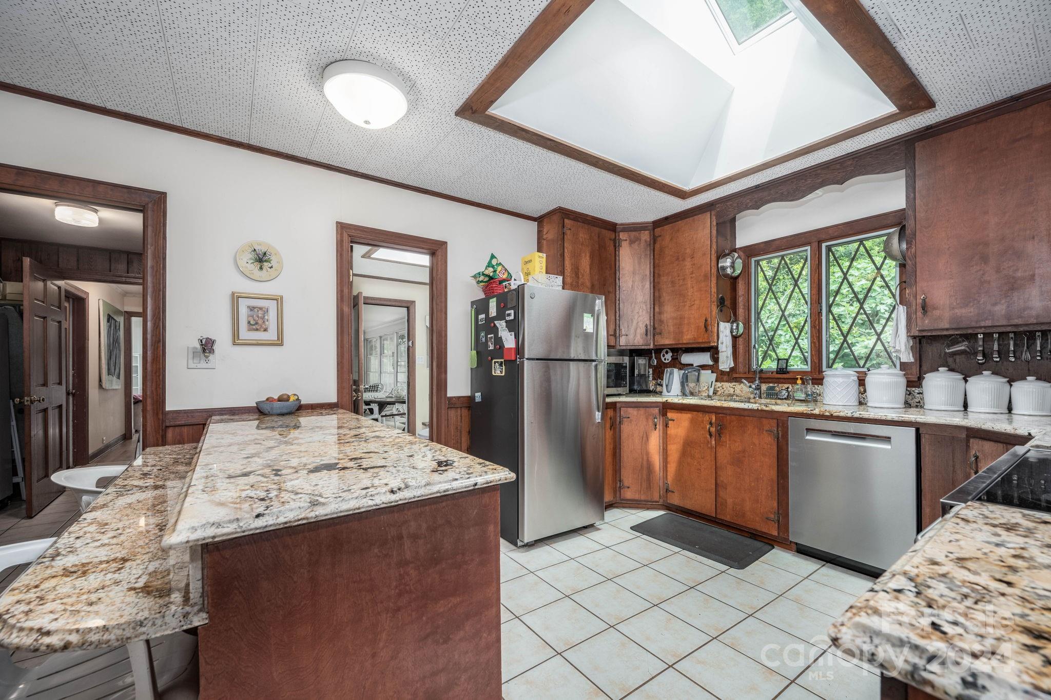 559 Lorimer Road Davidson, NC 28036 - Photo 12 of 39 a kitchen with stainless steel appliances kitchen island granite countertop a refrigerator and a sink