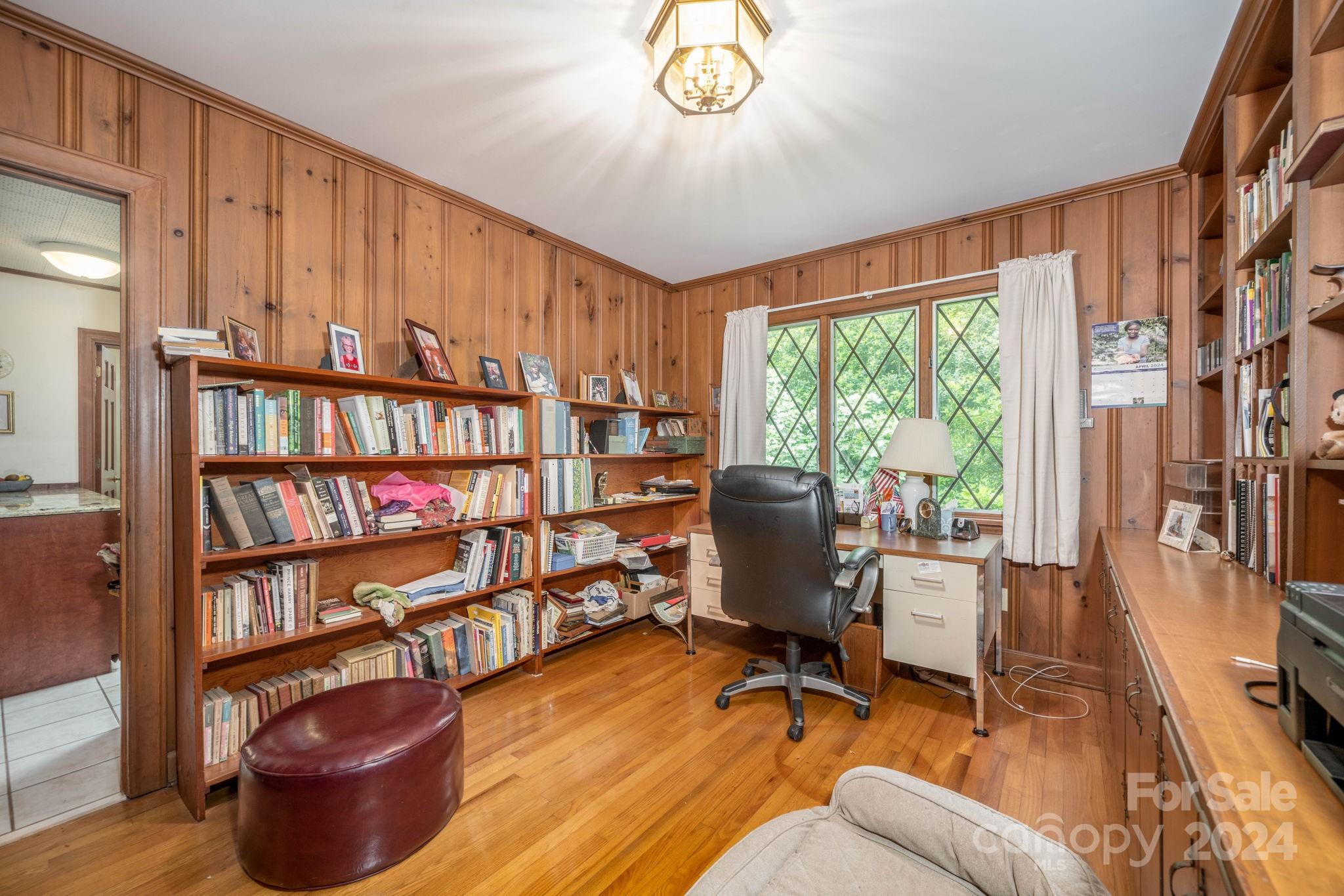 559 Lorimer Road Davidson, NC 28036 - Photo 18 of 39 a view of a livingroom with lounge chair and a bookshelf