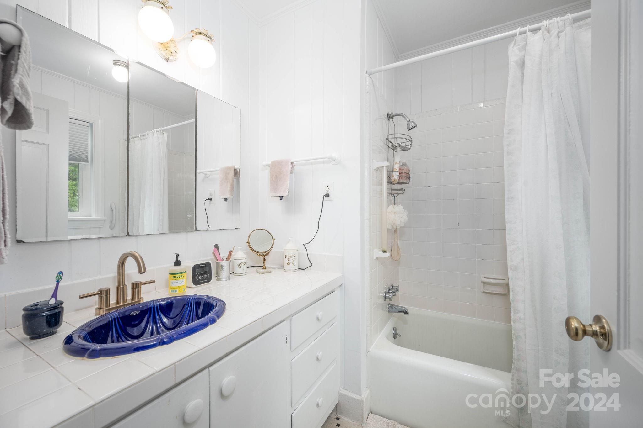 559 Lorimer Road Davidson, NC 28036 - Photo 25 of 39 a bathroom with a sink a vanity and a mirror