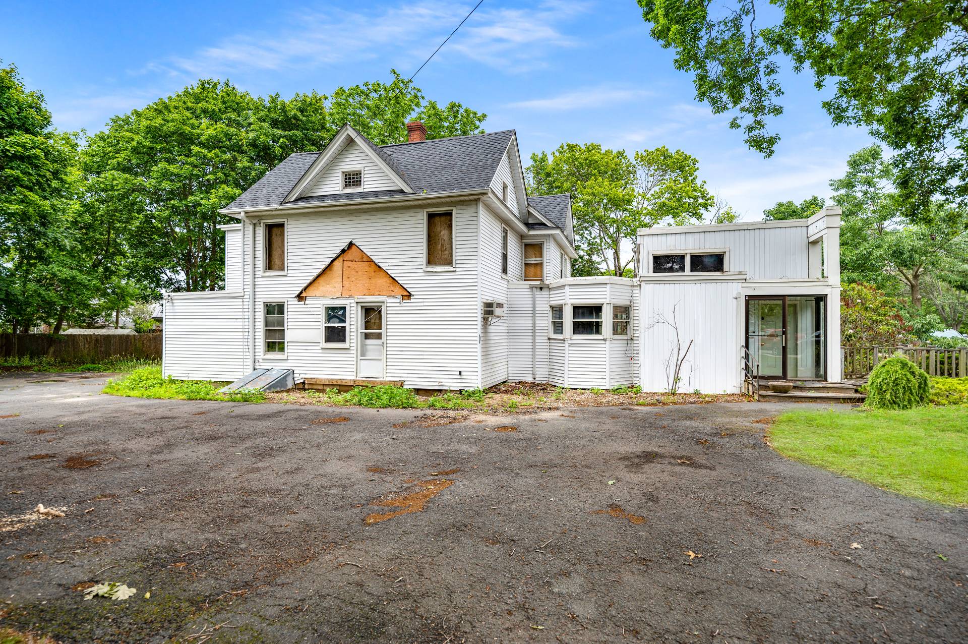 57 Mill Road Westhampton Beach, NY 11978 - Photo 12 of 20 a front view of a house with a yard and garage