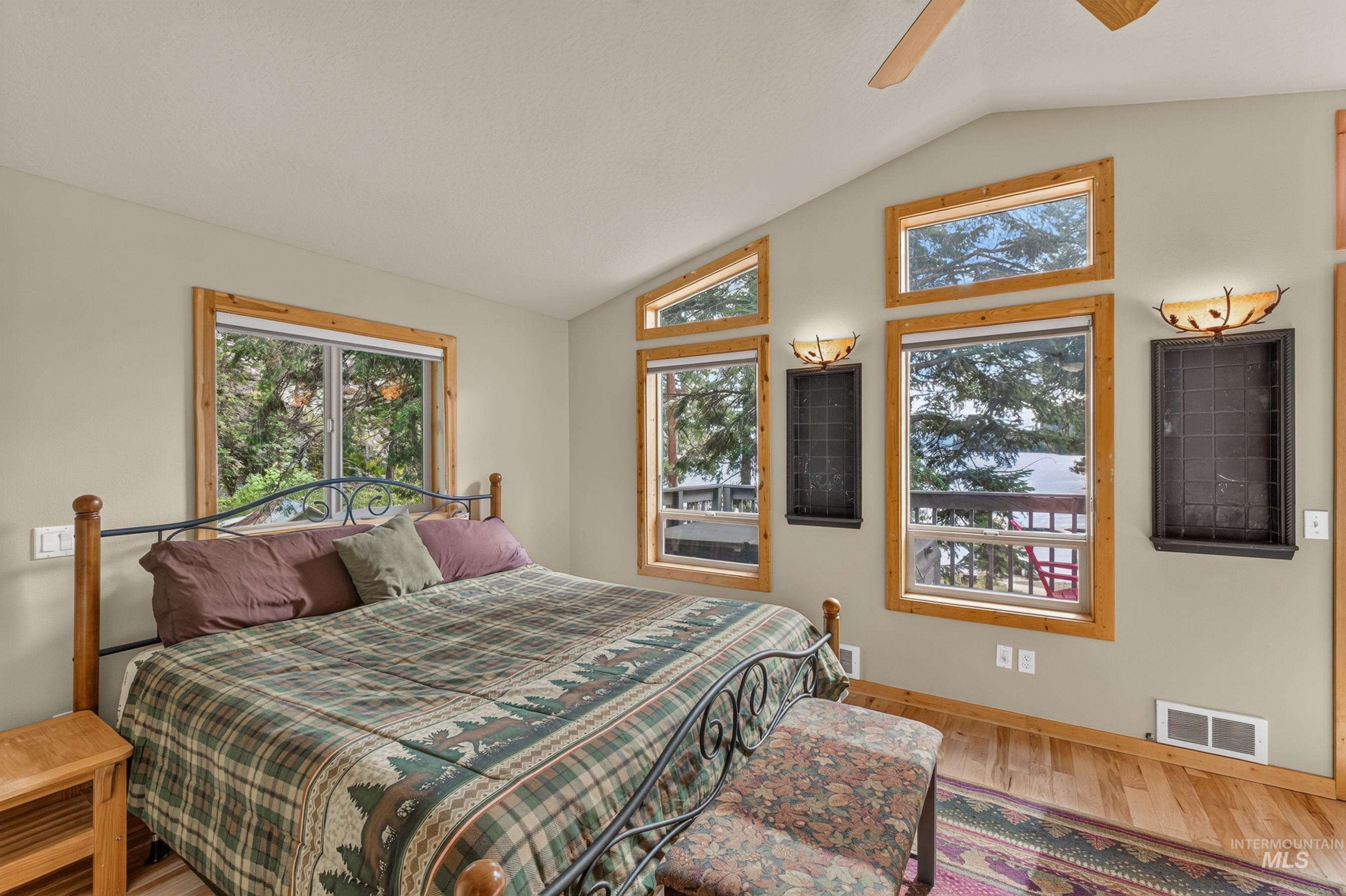 3531 Kp Cove Road McCall, ID 83638 - Photo 15 of 49 Wood-finish flooring, multiple windows, ceiling fan, crown molding, and wall sconces
