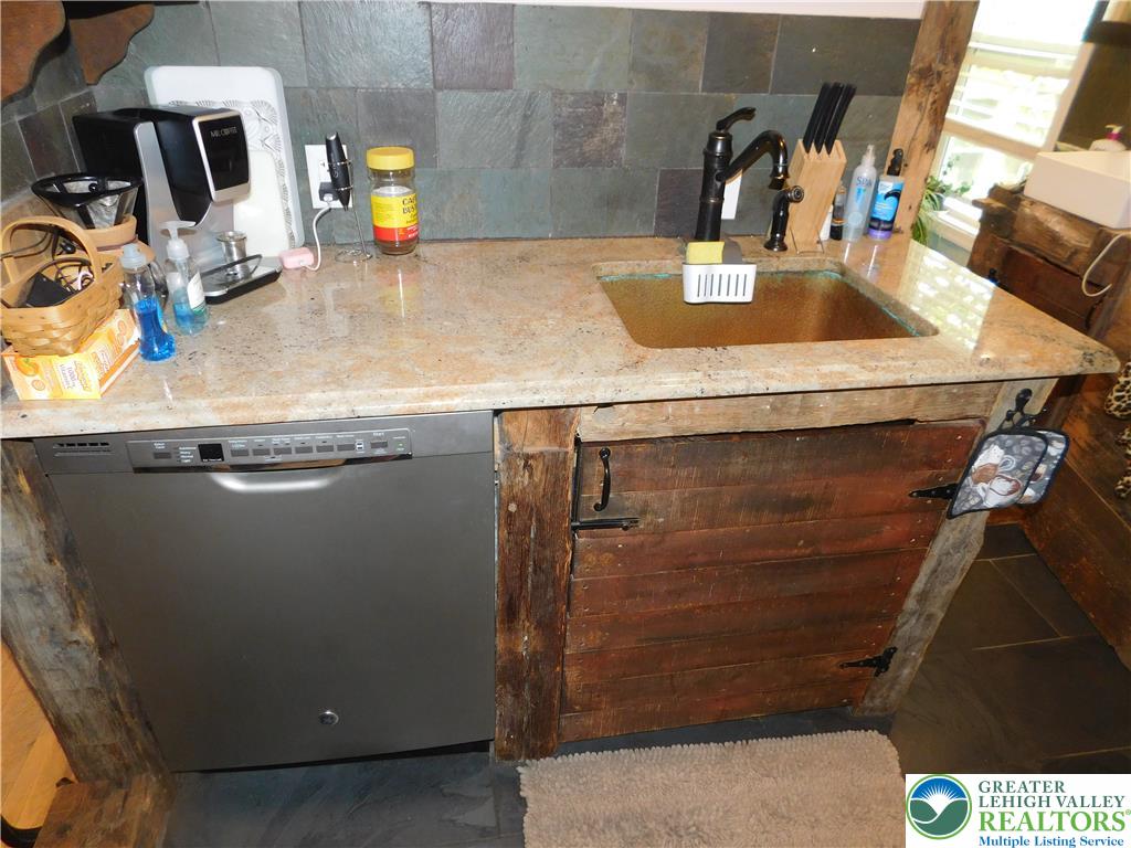 41 Reeder Street Mount Pocono, PA 18344 - Photo 19 of 41 Granite counters and a copper sink create a rustic yet refined kitchen space.