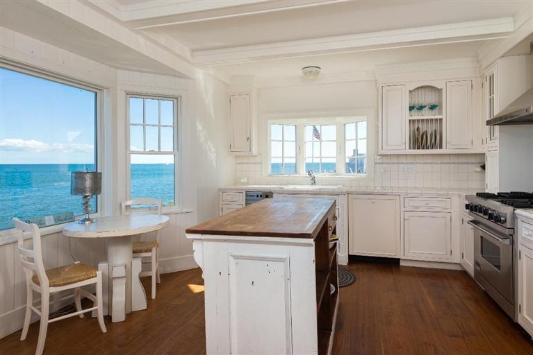 31 Starboard Lane Mashpee, MA 02649 - Photo 17 of 35 a kitchen with a table chairs sink and cabinets