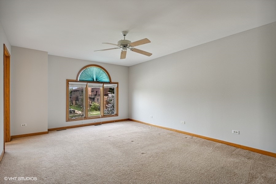 208 South Rush Street Itasca, IL 60143 - Photo 12 of 33 an empty room with chandelier fan and windows