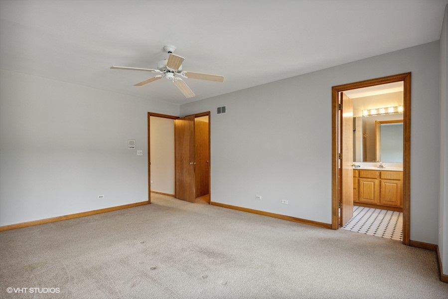 208 South Rush Street Itasca, IL 60143 - Photo 13 of 33 an empty room with chandelier fan and windows