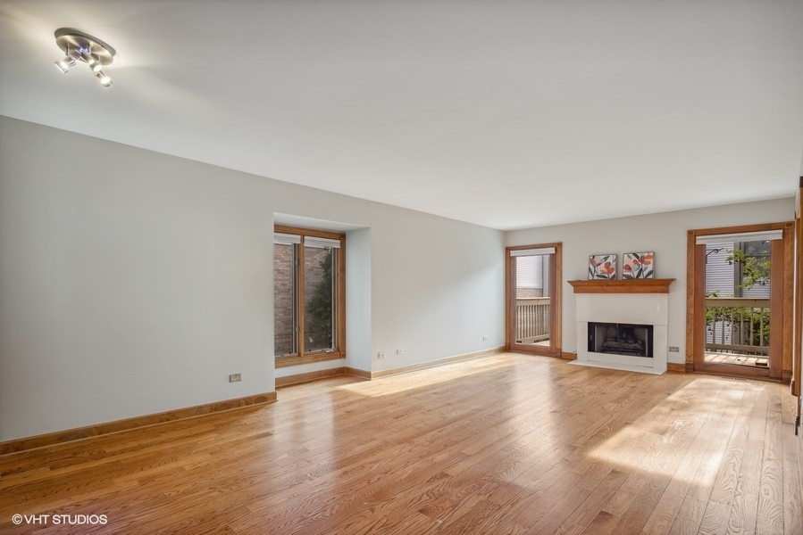 208 South Rush Street Itasca, IL 60143 - Photo 4 of 33 an empty room with floor to ceiling window and fireplace