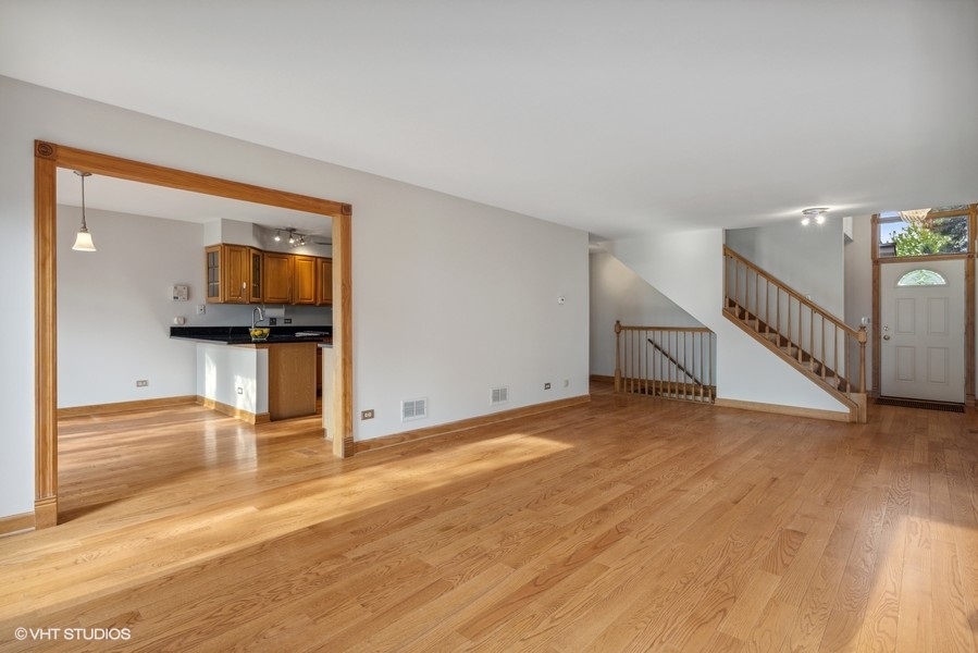 208 South Rush Street Itasca, IL 60143 - Photo 5 of 33 a view of a hallway with wooden floor and staircase
