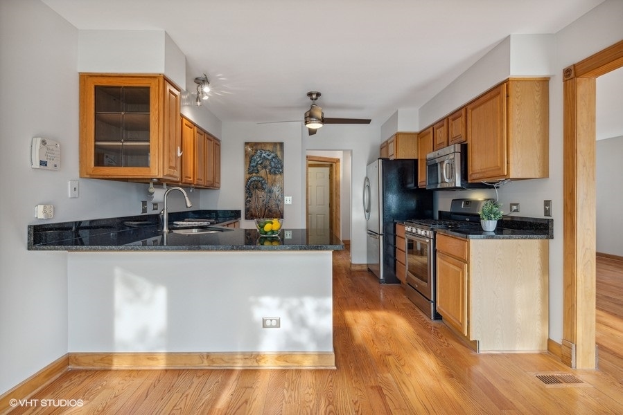 208 South Rush Street Itasca, IL 60143 - Photo 7 of 33 a kitchen with stainless steel appliances granite countertop a refrigerator a stove top oven a sink and dishwasher with wooden floor