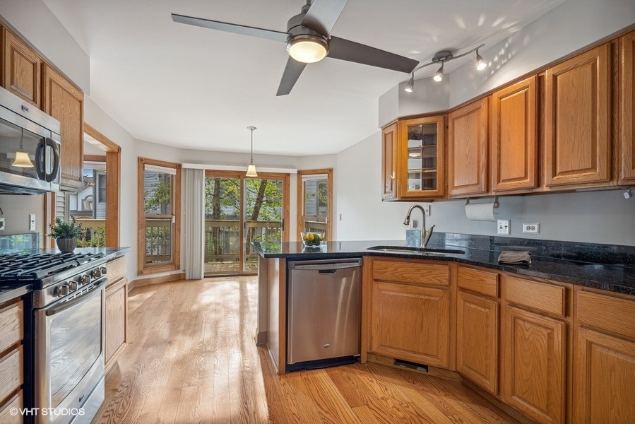 208 South Rush Street Itasca, IL 60143 - Photo 8 of 33 a kitchen with stainless steel appliances granite countertop a stove a sink dishwasher and a microwave oven with cabinets