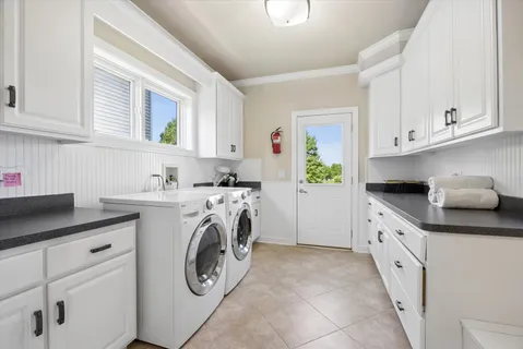 a kitchen with cabinets a washer and dryer