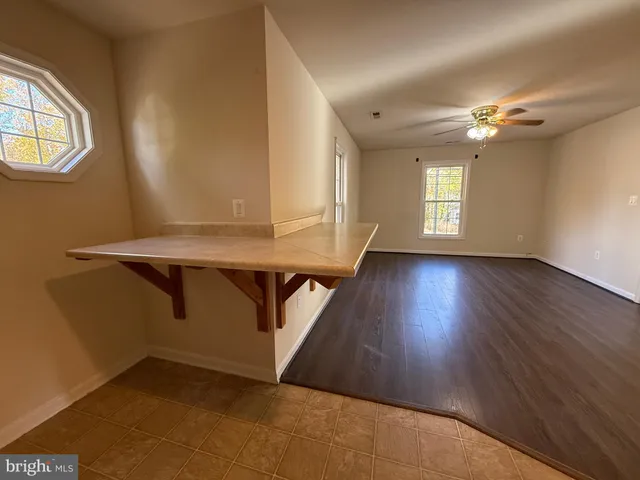 a view of room with window and wooden floor