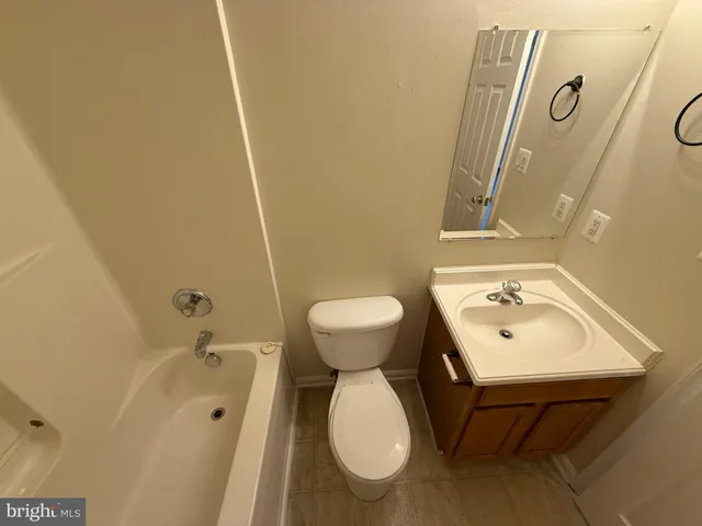 a bathroom with a sink mirror and toilet