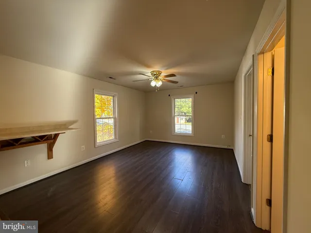 a view of a livingroom with wooden floor and a window