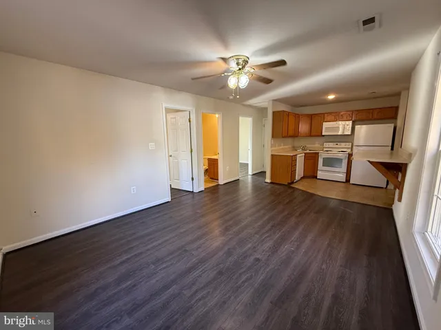 a view of a livingroom with hardwood floor and a ceiling fan