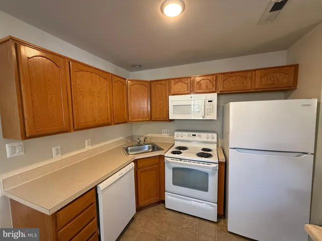 a kitchen with a stove a sink and a refrigerator