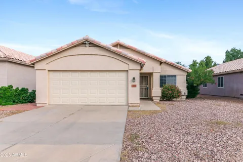 a view of a house with a yard and garage