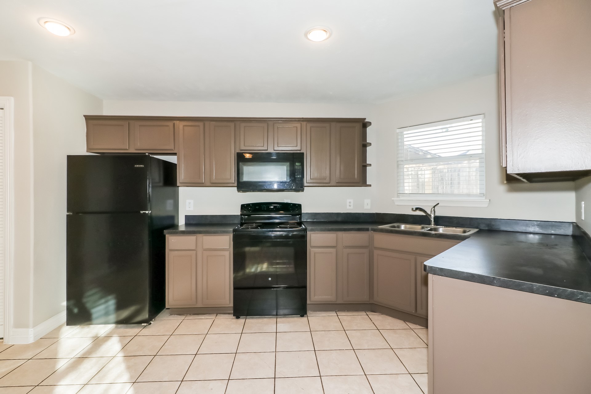 214 North Native Lane Houston, TX 77022 - Photo 6 of 18 a kitchen with a refrigerator sink and stove