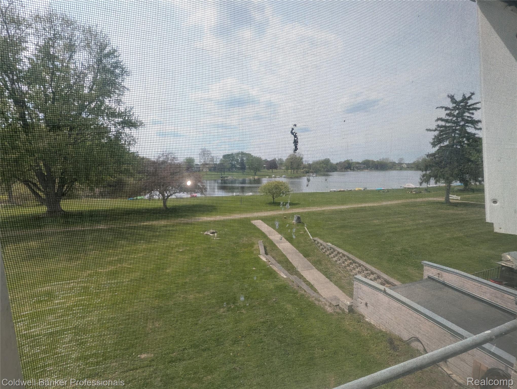 26945 Milford Road, Unit 8 New Hudson, MI 48165 - Photo 25 of 31 View of green lawn with a water view
