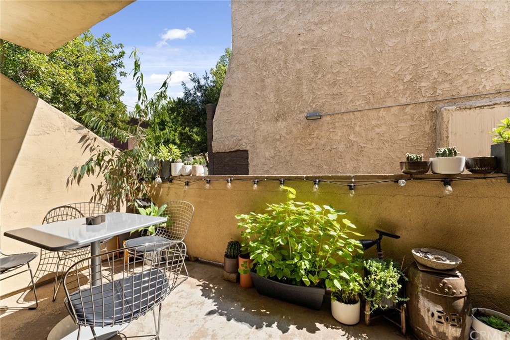 350 Burchett Street, Unit 101 Glendale, CA 91203 - Photo 11 of 27 a balcony with couple of chairs and potted plant