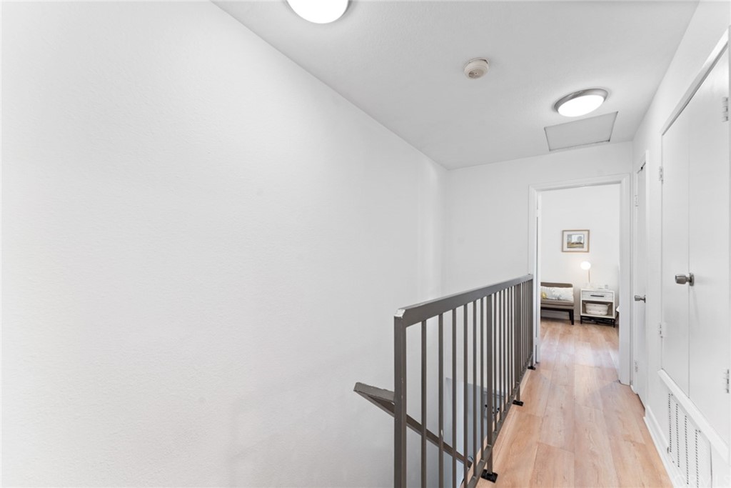 350 Burchett Street, Unit 101 Glendale, CA 91203 - Photo 14 of 27 a view of a hallway with a white stove and a wooden floor