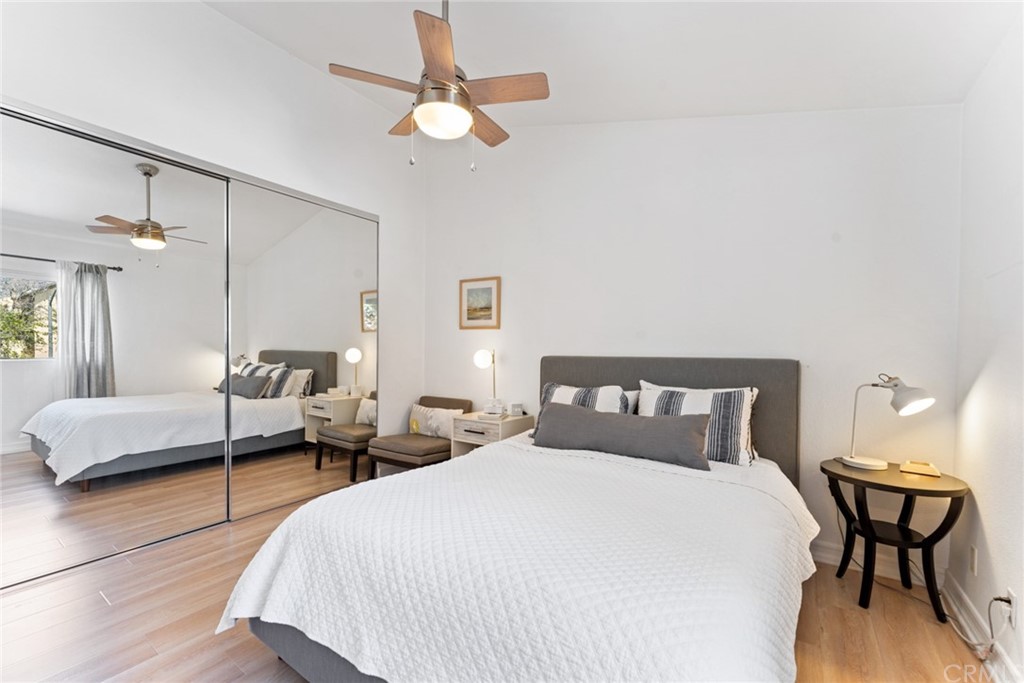 350 Burchett Street, Unit 101 Glendale, CA 91203 - Photo 20 of 27 a bedroom with beds and a large mirror with wooden floor