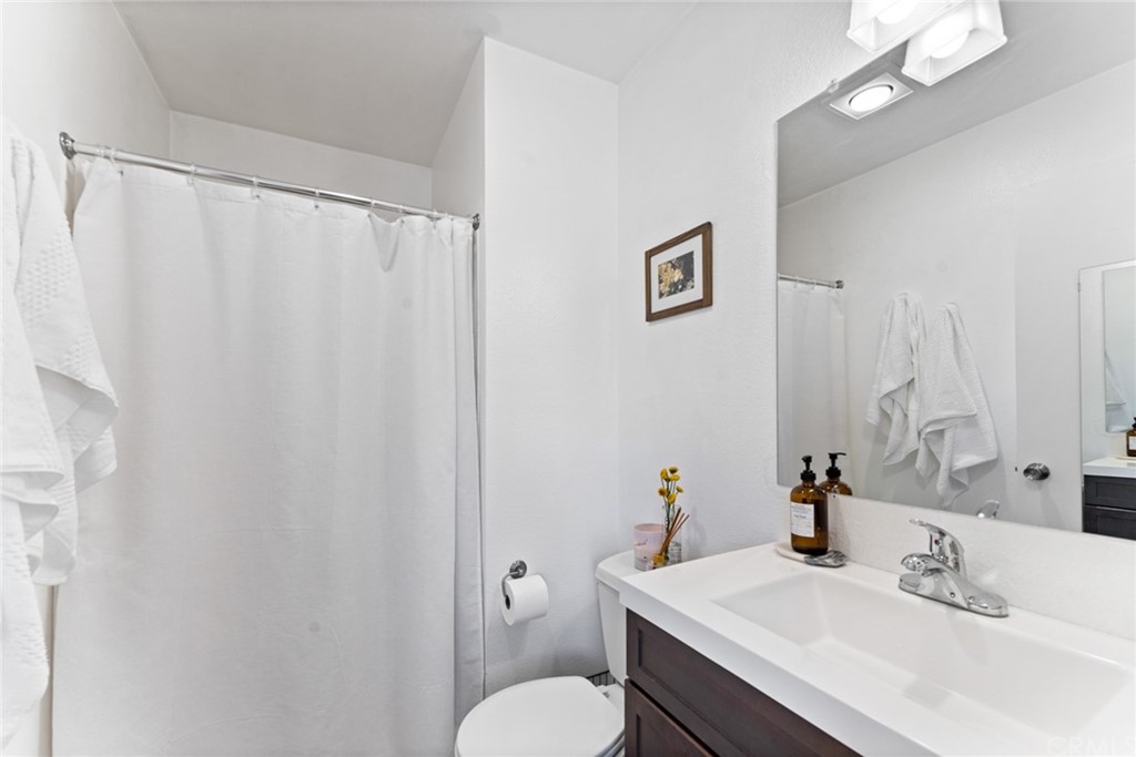 350 Burchett Street, Unit 101 Glendale, CA 91203 - Photo 21 of 27 a bathroom with a sink vanity mirror and toilet