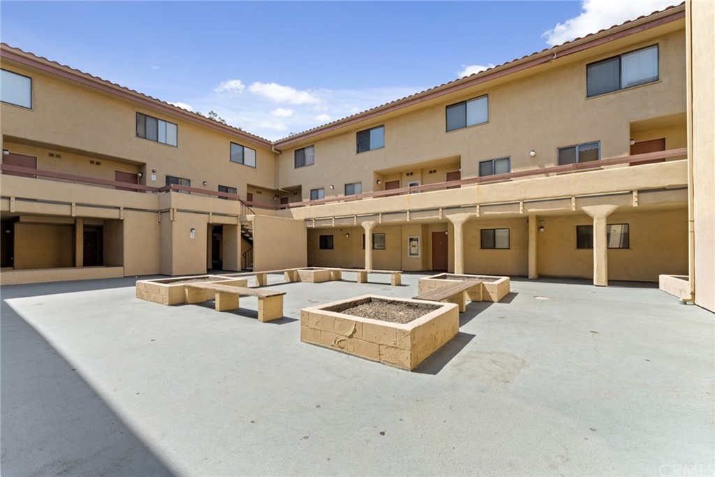 350 Burchett Street, Unit 101 Glendale, CA 91203 - Photo 23 of 27 a view of a house with swimming pool and sitting area