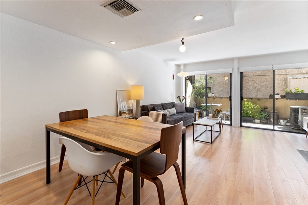 350 Burchett Street, Unit 101 Glendale, CA 91203 - Photo 6 of 27 a view of a dining room with furniture window and wooden floor