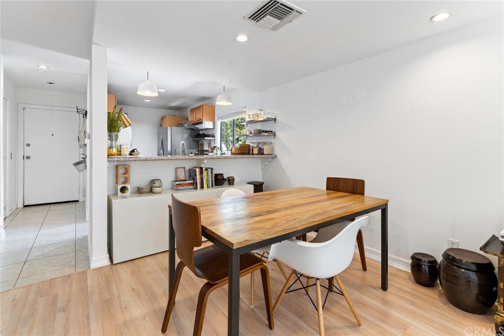 350 Burchett Street, Unit 101 Glendale, CA 91203 - Photo 7 of 27 a view of a dining room with furniture and a wooden floor