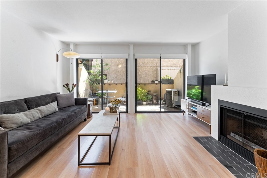 350 Burchett Street, Unit 101 Glendale, CA 91203 - Photo 9 of 27 a living room with furniture and a fireplace