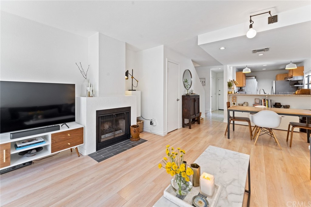 350 Burchett Street, Unit 101 Glendale, CA 91203 - Photo 10 of 27 a living room with furniture a flat screen tv and a fireplace
