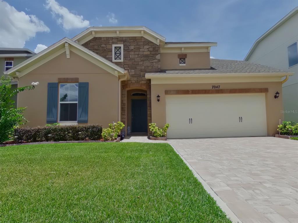 7047 Oxbow Road Minneola, FL 34715 - Photo 1 of 1 a front view of a house with a yard and garage