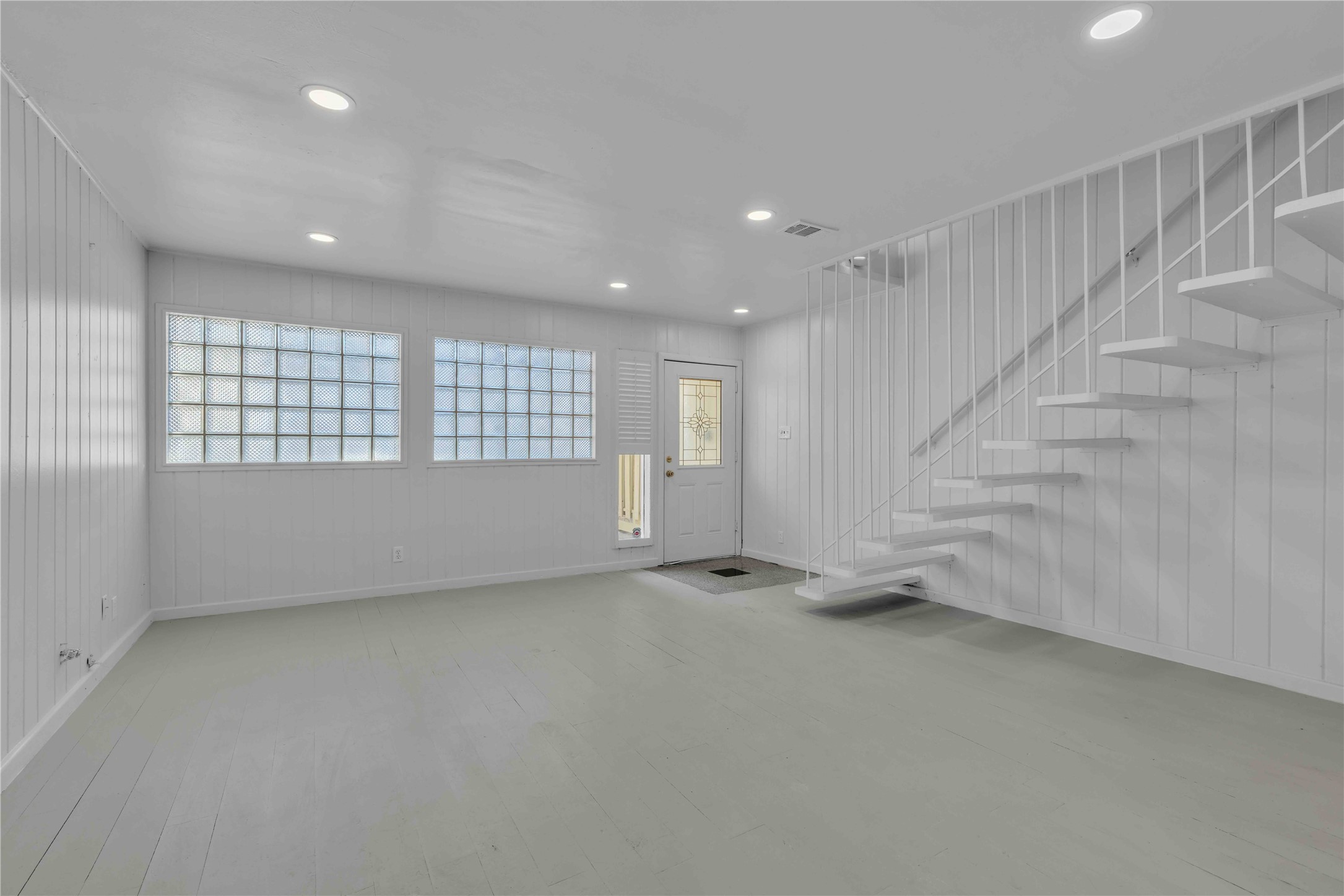 5210 Woodrow Avenue, Unit B Austin, TX 78756 - Photo 2 of 23 an empty room with windows