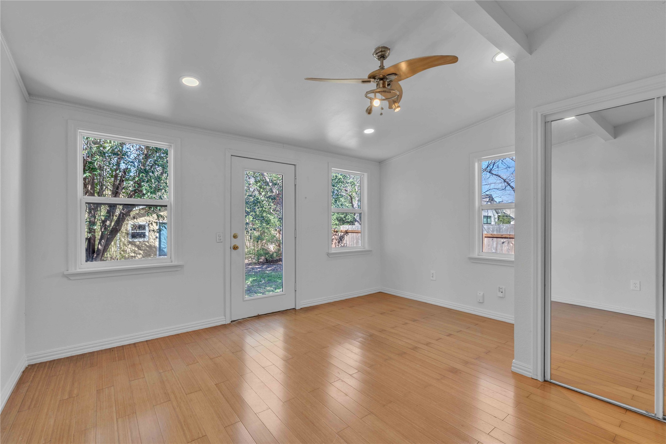 5210 Woodrow Avenue, Unit B Austin, TX 78756 - Photo 9 of 23 a view of an empty room with a window and wooden floor