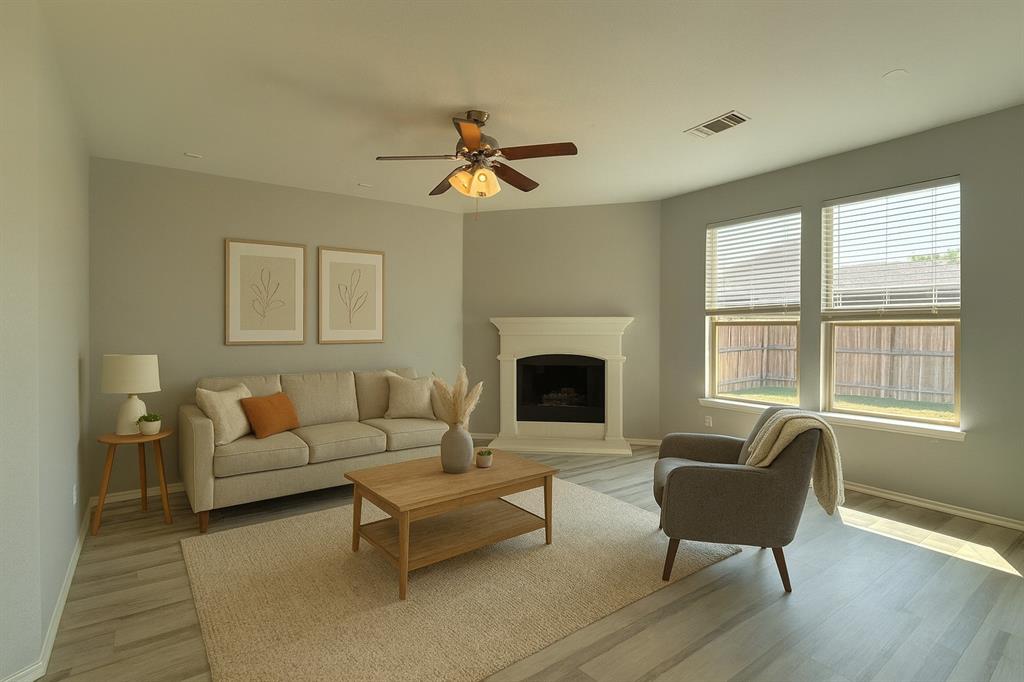 2047 Jack County Drive Forney, TX 75126 - Photo 9 of 20 a living room with furniture a fireplace and a window