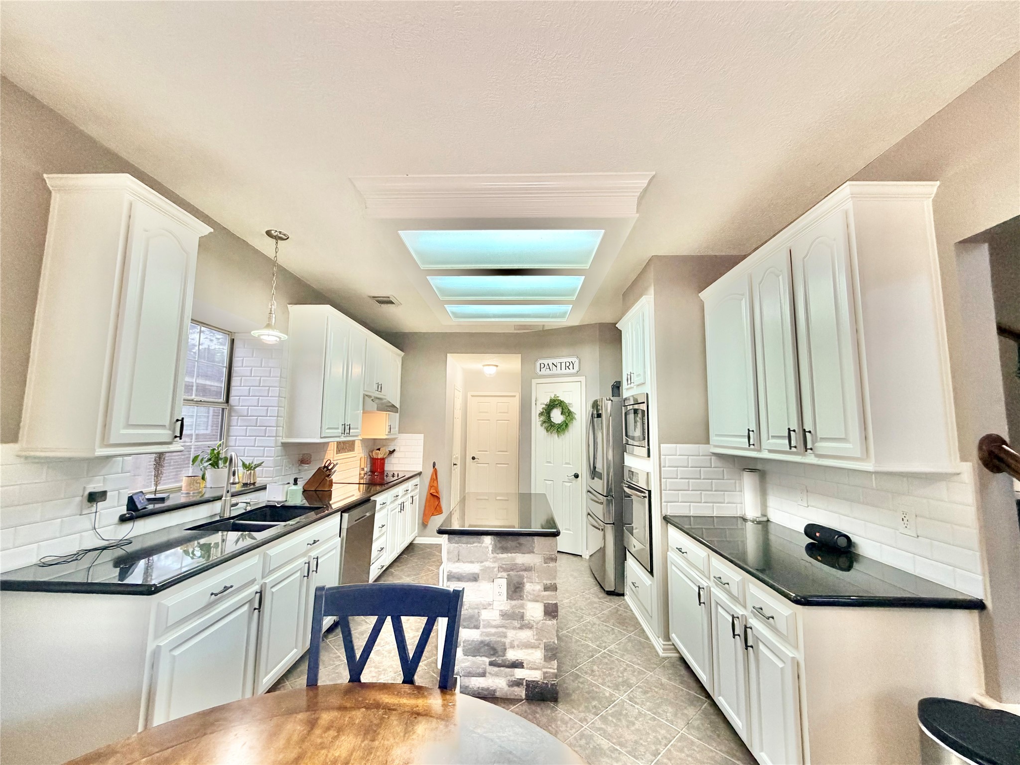 20110 Forest Drive Spring, TX 77388 - Photo 20 of 43 Bright and inviting kitchen featuring sleek countertops, modern cabinetry, and a central island perfect for culinary creations and gatherings.