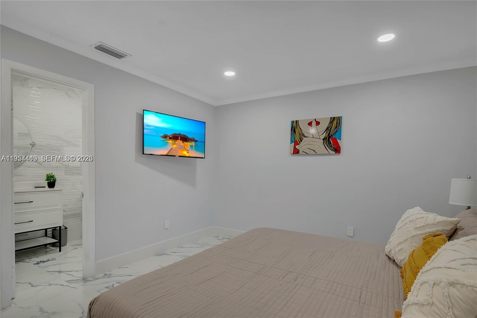 895 West 39th Place, Unit 1 Hialeah, FL 33012 - Photo 21 of 35 a bedroom with a bed and a couch