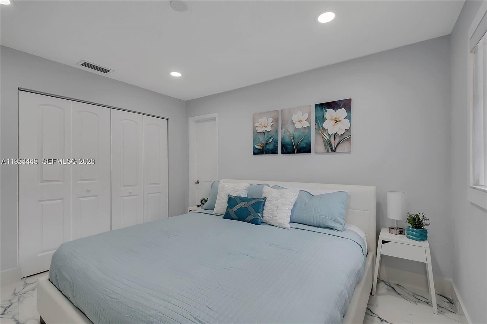 895 West 39th Place, Unit 1 Hialeah, FL 33012 - Photo 25 of 35 a bedroom with a bed and painting on the wall