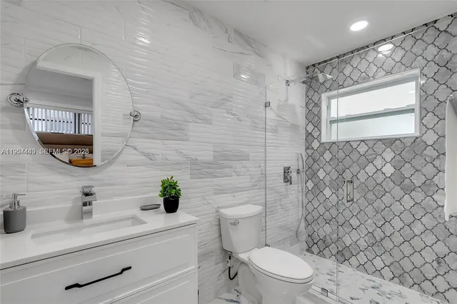 a bathroom with a sink a toilet and shower