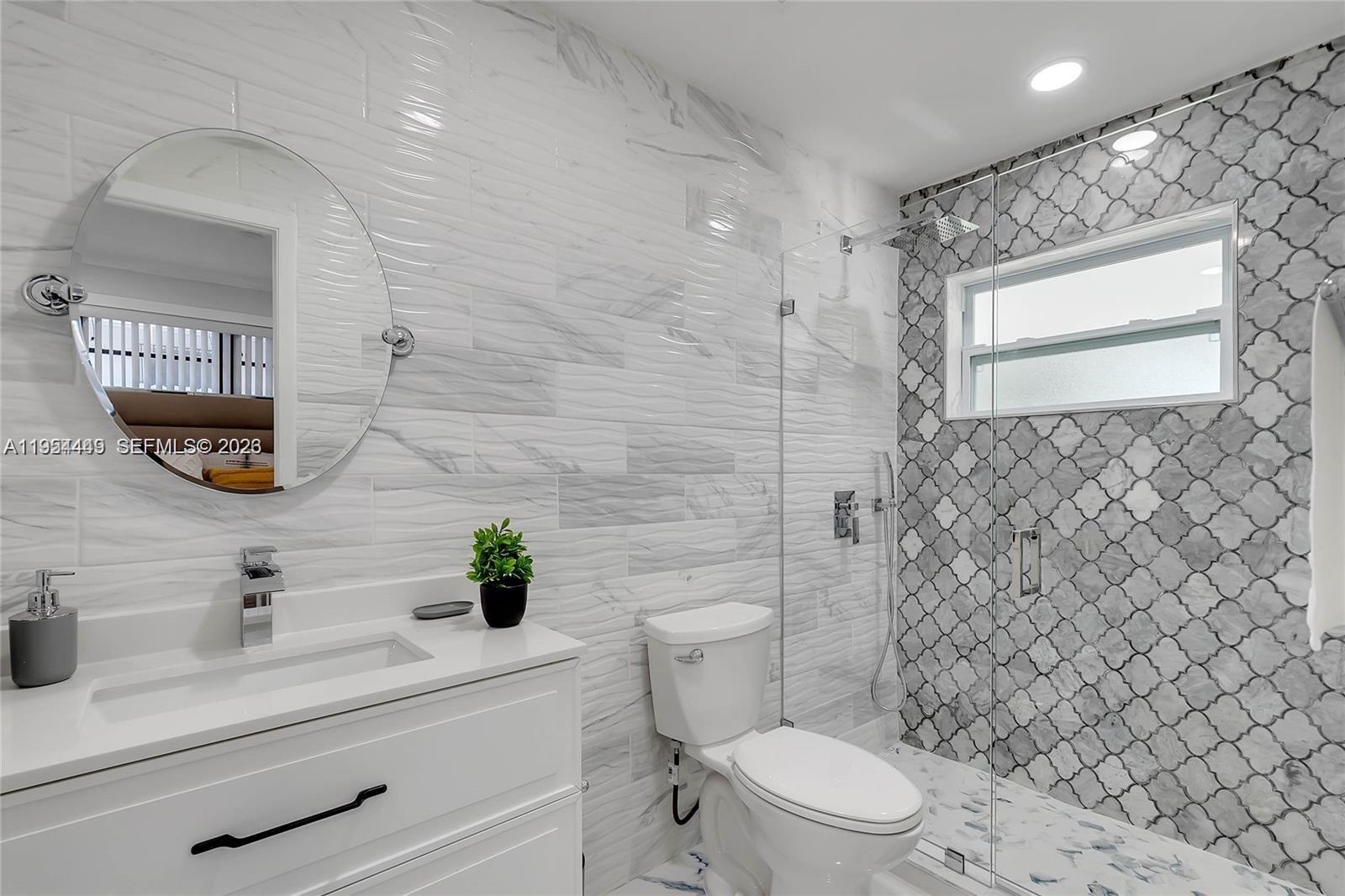 895 West 39th Place, Unit 1 Hialeah, FL 33012 - Photo 26 of 35 a bathroom with a sink a toilet and shower