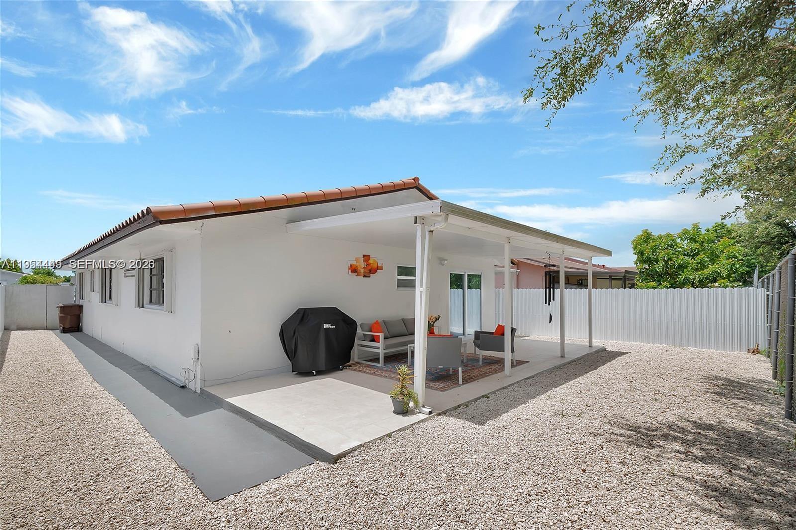895 West 39th Place, Unit 1 Hialeah, FL 33012 - Photo 29 of 35 a view of a house with backyard and a tree